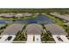 Aerial view showcases well-maintained homes in a neighborhood surrounding a serene lake at 3419 Lakewood Blvd, North Port, FL 34287