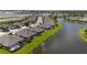 An aerial view of a neighborhood, showing the lake, houses, and well-manicured lawns at 3419 Lakewood Blvd, North Port, FL 34287