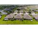 Aerial view showcases homes with screened lanais and spacious lawns in a planned community at 3419 Lakewood Blvd, North Port, FL 34287