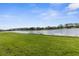 Picturesque backyard view showcasing a serene lake surrounded by well-maintained homes at 3419 Lakewood Blvd, North Port, FL 34287