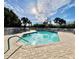 Inviting community pool surrounded by palm trees and lounge chairs under a sunny sky at 3419 Lakewood Blvd, North Port, FL 34287