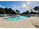 Community pool with clear blue water and surrounding lounge chairs, set in a lush landscape at 3419 Lakewood Blvd, North Port, FL 34287