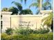 Villas of Sabal Trace II community sign with lush landscaping in a well-maintained neighborhood at 3419 Lakewood Blvd, North Port, FL 34287