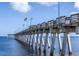 Long fishing pier extending into the ocean, offering scenic views and recreational opportunities at 3419 Lakewood Blvd, North Port, FL 34287