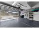 Spacious garage with a clean epoxy floor, storage cabinets and natural light at 3419 Lakewood Blvd, North Port, FL 34287