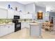 Bright kitchen boasts stainless steel sink, tile backsplash, and light colored tile flooring at 3419 Lakewood Blvd, North Port, FL 34287