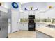 Bright kitchen has white cabinets, mosaic backsplash, stainless appliances and tile floors at 3419 Lakewood Blvd, North Port, FL 34287