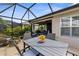 Inviting outdoor patio with dining table and chairs, ideal for entertaining and enjoying the sunshine at 3419 Lakewood Blvd, North Port, FL 34287