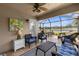 Inviting screened porch with comfortable seating, ceiling fan, and serene water views at 3419 Lakewood Blvd, North Port, FL 34287