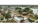 Aerial view showcasing the home's location within a neighborhood near a tranquil lake at 379 Peppertree Rd, Venice, FL 34293