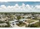 Residential neighborhood featuring well-maintained homes, green spaces, and the blue sky above at 379 Peppertree Rd, Venice, FL 34293