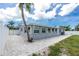 Side view of the home featuring a paved patio area, and fenced yard for privacy at 379 Peppertree Rd, Venice, FL 34293