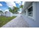 Side yard featuring a paved patio area, exterior shed and fenced yard at 379 Peppertree Rd, Venice, FL 34293