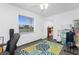 Bright bedroom with a ceiling fan, light colored walls, and a rug with sea green and blue colors at 379 Peppertree Rd, Venice, FL 34293
