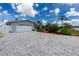 Attractive single-story home featuring a paved driveway, two-car garage and landscaped yard at 379 Peppertree Rd, Venice, FL 34293