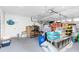 Spacious garage featuring a ceiling fan, plenty of storage boxes, and workspace at 379 Peppertree Rd, Venice, FL 34293