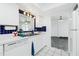 Traditional kitchen with white cabinets, stainless steel sink, and tile backsplash, perfect for cooking at 379 Peppertree Rd, Venice, FL 34293