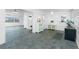 Open living space with neutral tile floor, ample lighting, and seamless transition to adjacent rooms at 379 Peppertree Rd, Venice, FL 34293