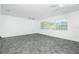 Spacious living room with a big window and ceiling fans, offering lots of natural light at 379 Peppertree Rd, Venice, FL 34293