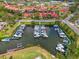 Aerial view of a marina with several covered boat slips at 403 Picasso Dr, Nokomis, FL 34275