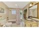 Elegant bathroom with marble countertop, decorative mirror, and tiled walls at 403 Picasso Dr, Nokomis, FL 34275
