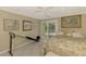 Bright bedroom with exercise equipment, comfortable bed, and sliding doors to an outdoor area at 403 Picasso Dr, Nokomis, FL 34275