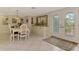 Elegant dining room with white floors and a decorative rug at 403 Picasso Dr, Nokomis, FL 34275