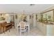 Open concept dining area features tile flooring and adjacent kitchen at 403 Picasso Dr, Nokomis, FL 34275