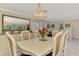 Bright and airy dining room with adjacent built-ins and tiled floors at 403 Picasso Dr, Nokomis, FL 34275