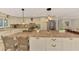Bright kitchen with updated appliances, island, eat-in area, and ample cabinet space at 403 Picasso Dr, Nokomis, FL 34275