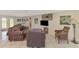 Spacious living room with plenty of seating and access to the dining room at 403 Picasso Dr, Nokomis, FL 34275
