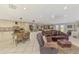 Open-concept living and kitchen area with white cabinets, stainless steel appliances, and cozy seating arrangements at 403 Picasso Dr, Nokomis, FL 34275