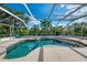 Inviting screened-in pool and lush landscaping create a private outdoor retreat at 403 Picasso Dr, Nokomis, FL 34275