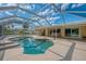 Screened pool with covered patio, outdoor dining, and beautiful blue skies at 403 Picasso Dr, Nokomis, FL 34275