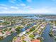 Stunning aerial view showcasing the waterfront community with access to open water and clear blue skies at 4255 13Th Ne Ln, St Petersburg, FL 33703