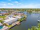 Beautiful aerial view of the home situated on a canal with dock and pool, surrounded by lush greenery at 4255 13Th Ne Ln, St Petersburg, FL 33703