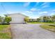 Attached garage with circular driveway, lush lawn, and mature, trimmed landscaping at 4255 13Th Ne Ln, St Petersburg, FL 33703