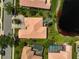 Aerial view showcases backyard with a patio and pool, nestled among manicured lawns and mature trees at 4321 Via Del Santi Dr, Venice, FL 34293