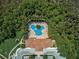 Bird's eye view of a community pool surrounded by mature trees and a tile roofed building at 4321 Via Del Santi Dr, Venice, FL 34293