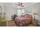 Bedroom featuring a wicker bed frame, ceiling fan, and decorative accents at 4321 Via Del Santi Dr, Venice, FL 34293