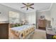 Bedroom with ceiling fan, comfortable bed, and decoratively styled bedside tables at 4321 Via Del Santi Dr, Venice, FL 34293