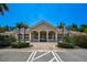 A beautifully maintained community clubhouse with parking and manicured landscaping at 4321 Via Del Santi Dr, Venice, FL 34293