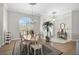 Dining room featuring elegant decor, a chandelier, an arched window, and hardwood floors at 4321 Via Del Santi Dr, Venice, FL 34293