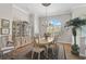 Well-lit dining area featuring a display cabinet, hardwood floors, and an arched window at 4321 Via Del Santi Dr, Venice, FL 34293