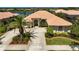 Stunning single-story home featuring a tile roof, lush landscaping, and a circular driveway at 4321 Via Del Santi Dr, Venice, FL 34293