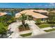 Aerial view of a well-maintained home featuring lush landscaping and a circular driveway at 4321 Via Del Santi Dr, Venice, FL 34293