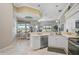 Bright eat-in kitchen with stone countertops and stainless steel appliances overlooks a beautifully landscaped backyard and water view at 4321 Via Del Santi Dr, Venice, FL 34293