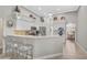 Bright kitchen featuring white cabinetry, stainless appliances, a breakfast bar, and a dining area at 4321 Via Del Santi Dr, Venice, FL 34293