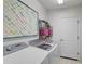 Laundry room featuring modern washer and dryer with colorful art at 4321 Via Del Santi Dr, Venice, FL 34293