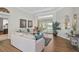Inviting living room with wood floors, natural light, a comfortable couch and picturesque backyard views at 4321 Via Del Santi Dr, Venice, FL 34293